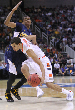 Michael Carter-Williams #1 drives to the basket against Tyrone Wallace #3 of the California Golden Bears.