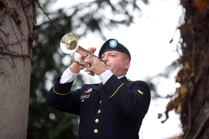 Philip Kovach, a member of the 198th Army Band Buglers, plays taps during the ceremonies on Veterans Day on Monday.