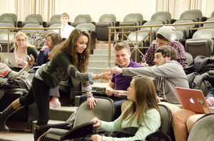 Adrianna Kam, Board of Elections and Membership chair, passes out ballots at Monday night's SA meeting. Two students were elected to the University Senate, one student was elected to the Judicial Review Board and one student was elected to the assembly.