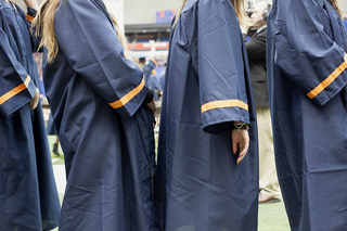 Syracuse University undergraduates wait in line as they are guided to their seats inside the Carrier Dome.