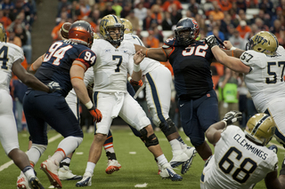 SU defensive linemen Eric Crume and Robert Welsh hurry Savage.