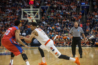 Michael Gbinije drives past a Dayton defender and into the Flyers zone. 