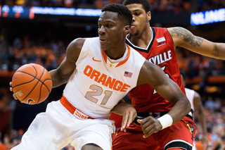 Tyler Roberson looks to make a move against Louisville's Wayne Blackshear. The SU sophomore had four points in 17 first-half minutes.