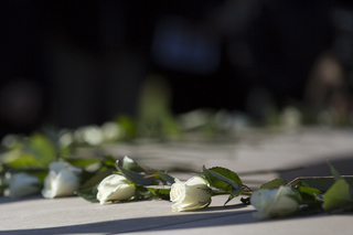 Scholars placed white roses on the Remembrance Wall to honor the lives that were lost.