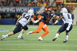 Dungey tries to avoid two defenders. 