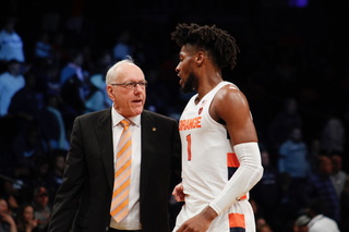 Head coach Jim Boeheim talks with freshman Quincy Guerrier as he heads to the bench.