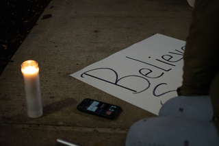 @standwithsurvivorssu made signs to help further their cause during the vigil.